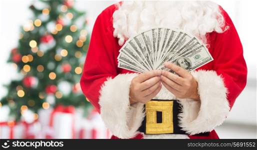 christmas, holidays, winning, currency and people concept - close up of santa claus with dollar money over living room with tree