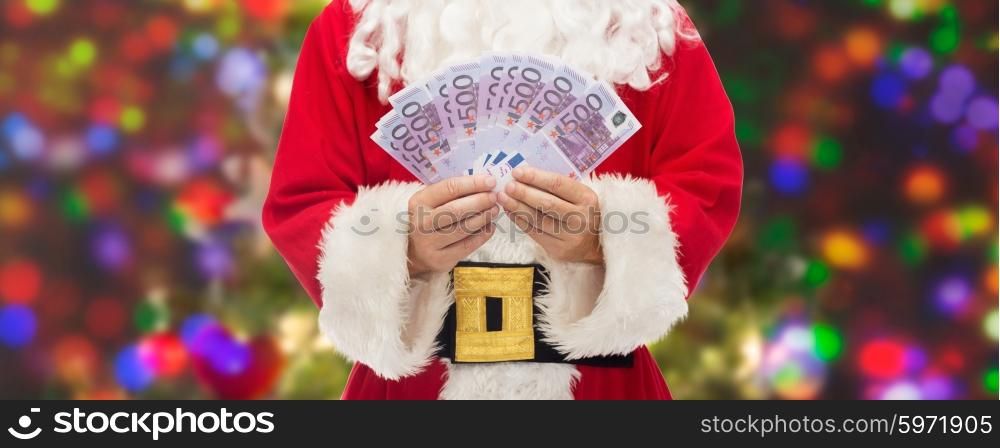 christmas, holidays, winning, currency and people concept - close up of santa claus with euro money over lights background