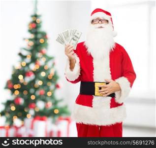 christmas, holidays, winning, currency and people concept - man in costume of santa claus with dollar money over living room with tree