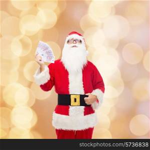 christmas, holidays, winning, currency and people concept - man in costume of santa claus with euro money over beige background