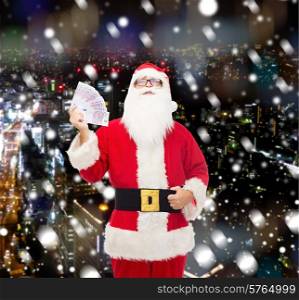 christmas, holidays, winning, currency and people concept - man in costume of santa claus with euro money over snowy night city background