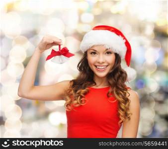 christmas, holidays, winter, happiness and people concept - smiling woman in santa helper hat with jingle bells over lights background