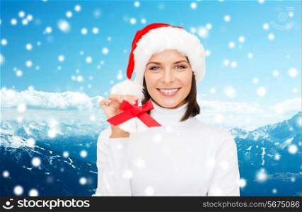 christmas, holidays, winter, happiness and people concept - smiling woman in santa helper hat with jingle bells over blue snowy mountains background