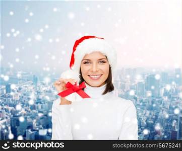 christmas, holidays, winter, happiness and people concept - smiling woman in santa helper hat with jingle bells over snowy city background