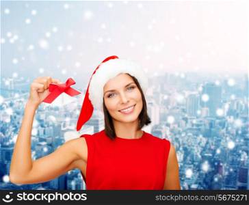 christmas, holidays, winter, happiness and people concept - smiling woman in santa helper hat with jingle bells over snowy city background
