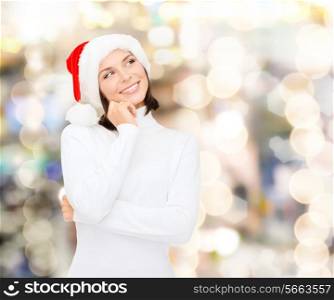 christmas, holidays, winter, happiness and people concept - thinking and smiling woman in santa helper hat over lights background