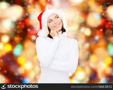 christmas, holidays, winter, happiness and people concept - thinking and smiling woman in santa helper hat over red lights background