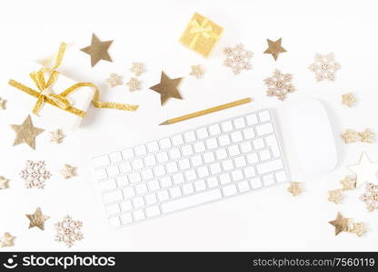 Christmas home office desk with computer, notebook, gifts, christmas gold decorations. Flat lay, top view, copy space.. Christmas home office desk