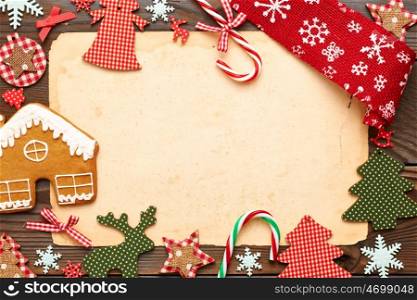 Christmas homemade gingerbread cookie and handmade decoration on wooden background