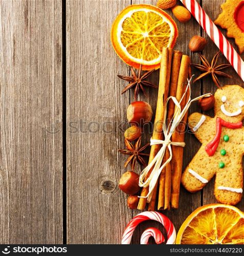 Christmas homemade gingerbread cookie and spices over wooden table