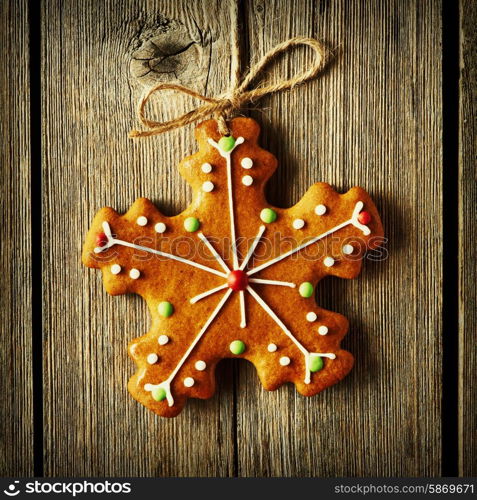 Christmas homemade gingerbread cookie over wooden background