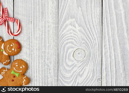 Christmas homemade gingerbread cookies and decoration on wooden background