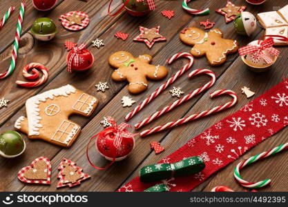 Christmas homemade gingerbread cookies and handmade decoration on wooden background