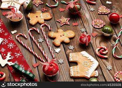 Christmas homemade gingerbread cookies and handmade decoration on wooden background