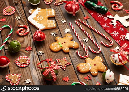 Christmas homemade gingerbread cookies and handmade decoration on wooden background