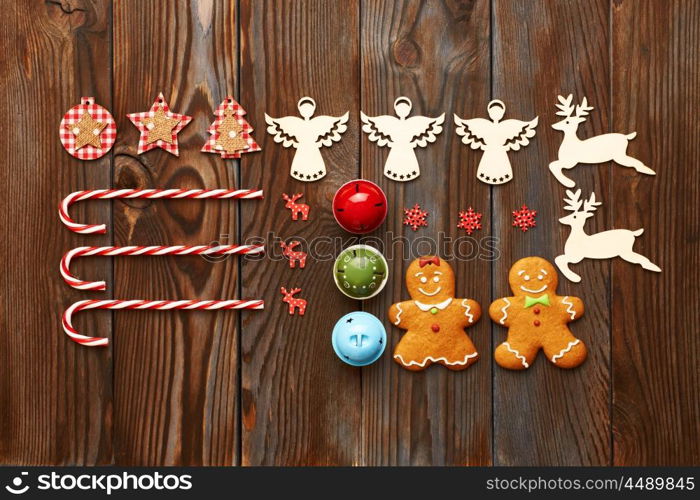 Christmas homemade gingerbread cookies and handmade decoration on wooden background flat lay still life