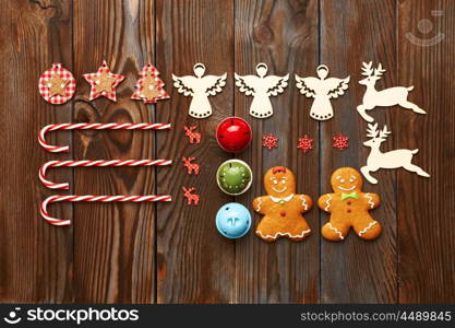 Christmas homemade gingerbread cookies and handmade decoration on wooden background flat lay still life