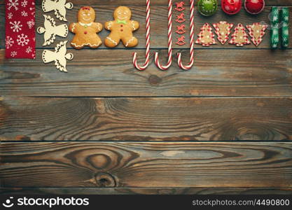 Christmas homemade gingerbread cookies and handmade decoration on wooden background flat lay still life