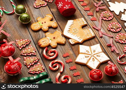 Christmas homemade gingerbread cookies and handmade decoration on wooden background flat lay still life