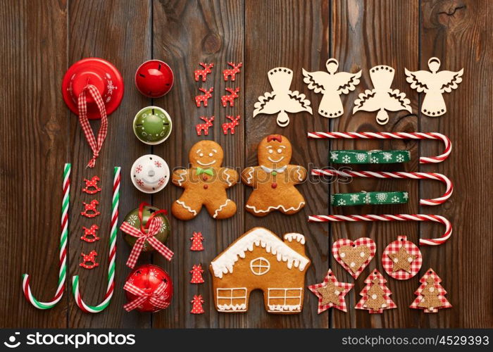 Christmas homemade gingerbread cookies and handmade decoration on wooden background flat lay still life