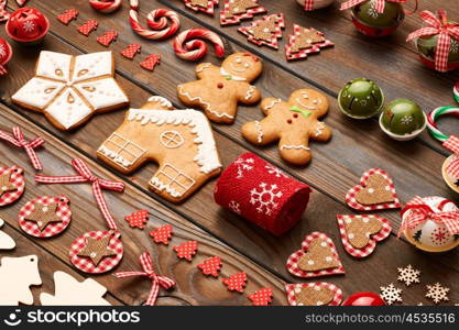 Christmas homemade gingerbread cookies and handmade decoration on wooden background flat lay still life