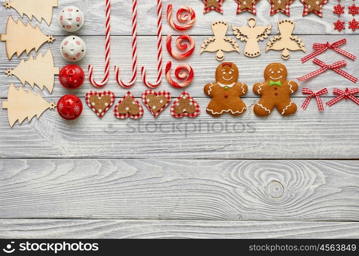 Christmas homemade gingerbread cookies and handmade decoration on wooden background flat lay still life