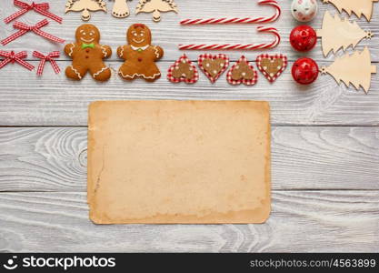 Christmas homemade gingerbread cookies and handmade decoration on wooden background flat lay still life