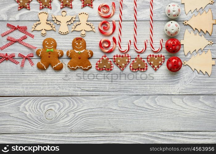 Christmas homemade gingerbread cookies and handmade decoration on wooden background flat lay still life