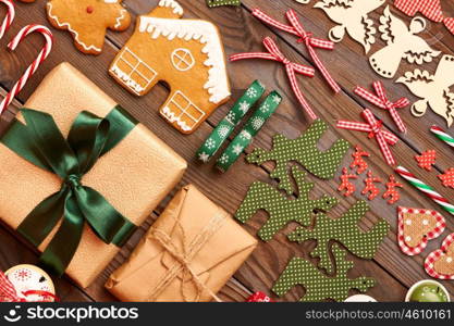 Christmas homemade gingerbread cookies and handmade decoration on wooden background flat lay still life