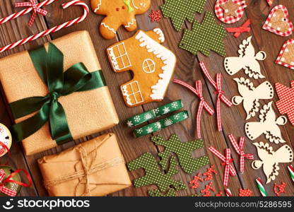 Christmas homemade gingerbread cookies and handmade decoration on wooden background flat lay still life