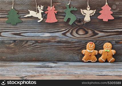 Christmas homemade gingerbread cookies on wooden background. Gingerbread couple - man and woman.