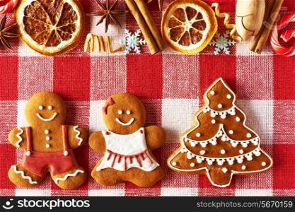 Christmas homemade gingerbread couple and tree on tablecloth