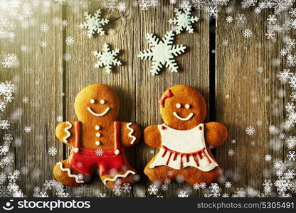 Christmas homemade gingerbread couple cookies on wooden table