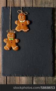 Christmas homemade gingerbread couple cookies over slate