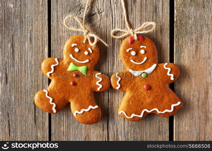 Christmas homemade gingerbread couple cookies over wooden background