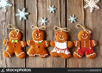 Christmas homemade gingerbread couple cookies over wooden background