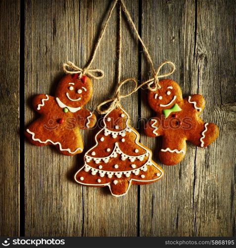 Christmas homemade gingerbread couple cookies over wooden background