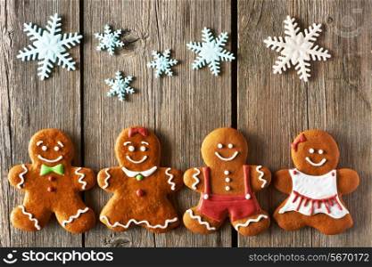Christmas homemade gingerbread couples on wooden table