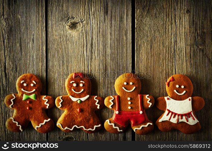 Christmas homemade gingerbread couples on wooden table
