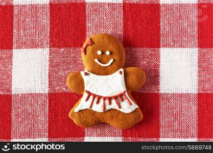 Christmas homemade gingerbread girl on tablecloth