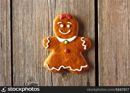 Christmas homemade gingerbread girl on wooden table