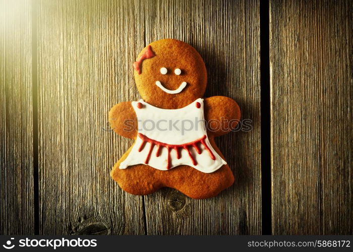 Christmas homemade gingerbread girl on wooden table