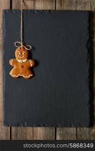 Christmas homemade gingerbread girl over slate background