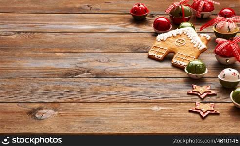 Christmas homemade gingerbread house cookie and decoration on wooden background