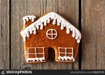 Christmas homemade gingerbread house cookie on wooden table