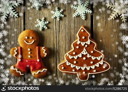 Christmas homemade gingerbread man and tree on wooden table