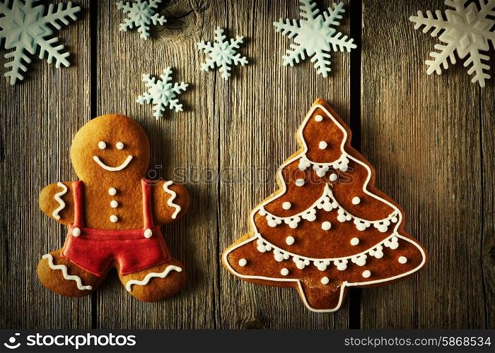 Christmas homemade gingerbread man and tree on wooden table