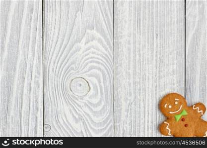 Christmas homemade gingerbread man cookie on wooden background