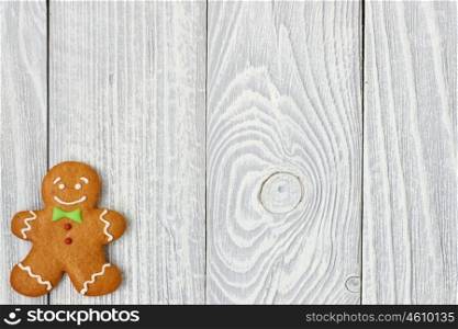 Christmas homemade gingerbread man cookie on wooden background