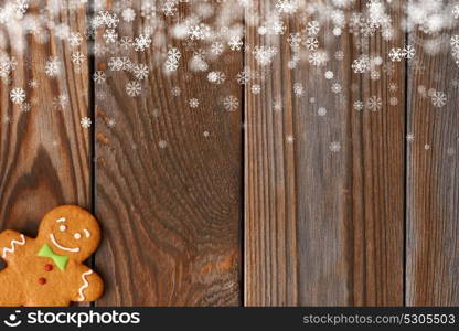 Christmas homemade gingerbread man cookie on wooden background